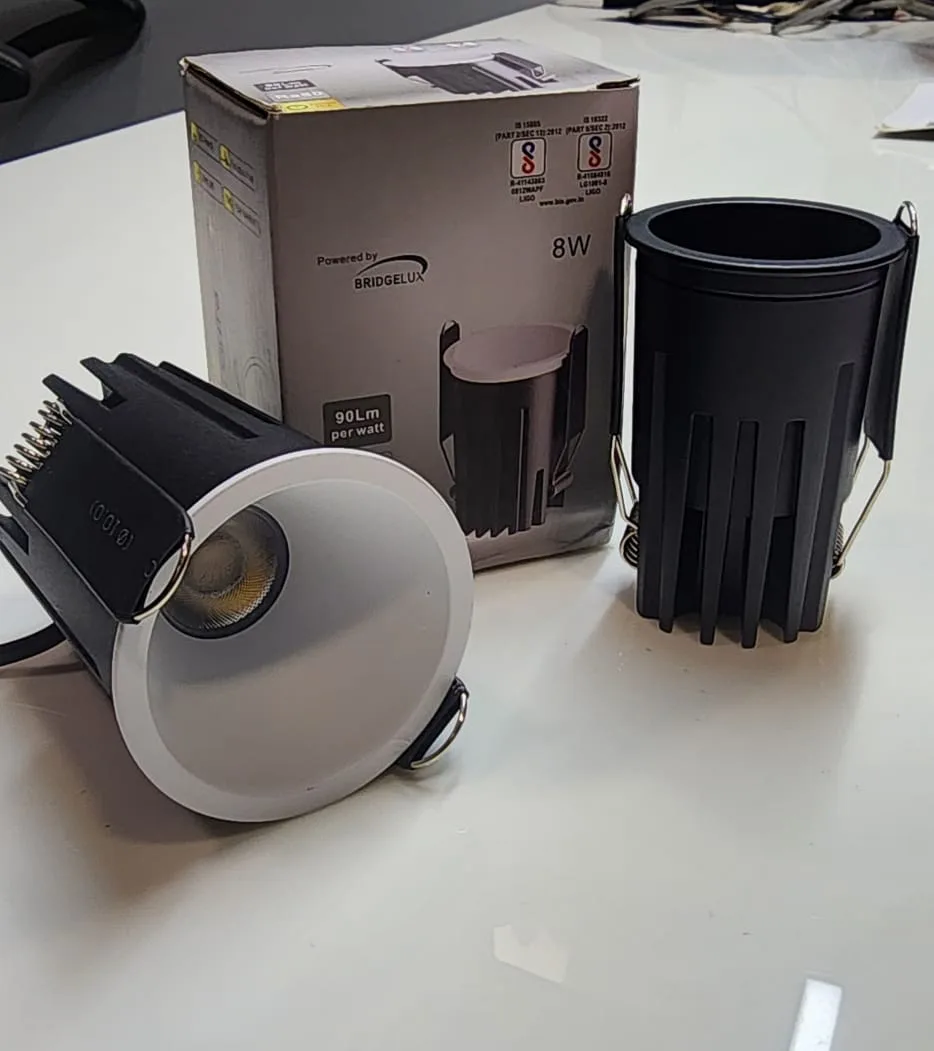 Deep recessed anti-glare downlight next to a black cylinder housing
